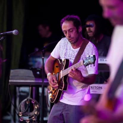 Playing guitar under stage lights